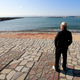 A man looks out at the sea after the tsunami warning was lifted at Onahama coastal region in Iwaki, Fukushima, on Tuesday. Image: Shizuo Kambayashi/AP